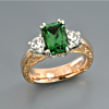 custom-white-and-yellow-gold-three-stone-tsavorite-garnet-diamond-engraved-engagement-ring.jpg
