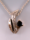 Garnet in silver and 14k yellow gold pendant